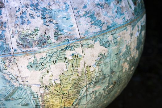 Old cracked and weathered globe focusing on South America.