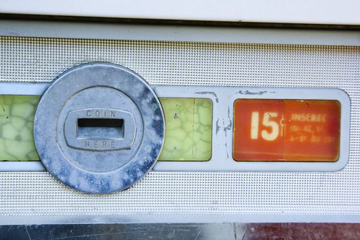 Coin slot and 15 cent price on old vending machine