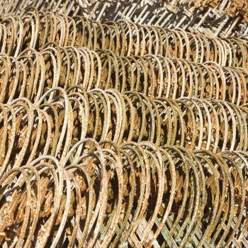 Metal fencing stacked in a row.