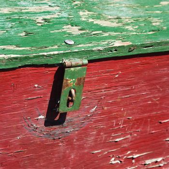 Old red and green weathered wooden storage container.