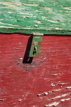 Old red and green weathered wooden storage container.