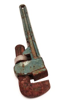 Rusty adjustable spanner on a white background