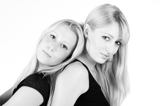 Studio portrait of two sisters looking sensual into the camera