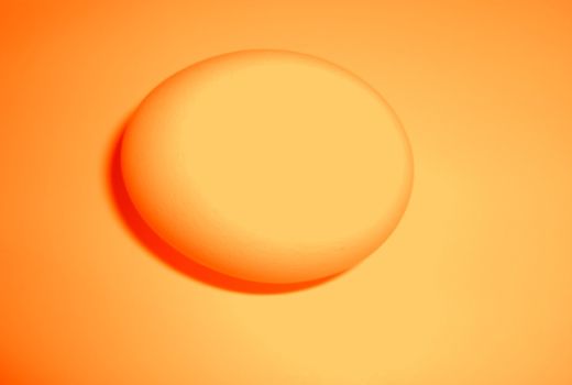 an orange egg on an orange background