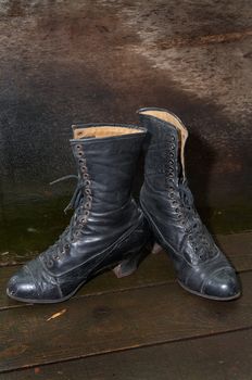 Old female boots on wooden to a floor