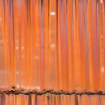 Closeup of metal orange siding.