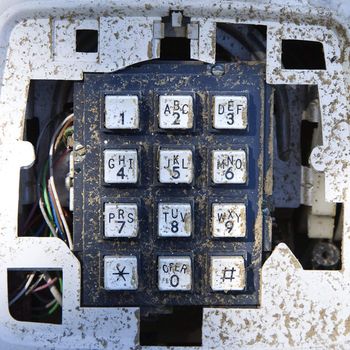 Closeup of old dirty telephone keypad.