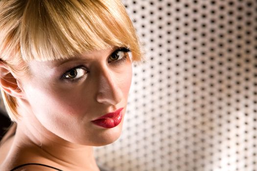 Portrait of a beautiful blond girl looking at you