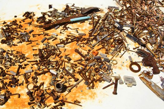 Old rusty nails and screws on table