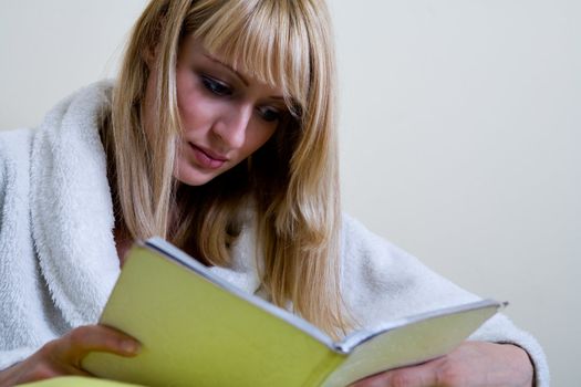 Blond model is reading a book