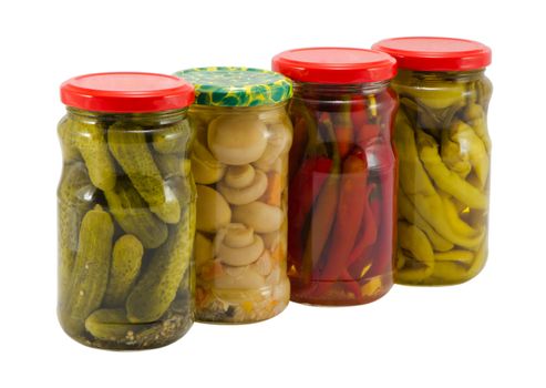 ecological natural food resource for winter mushroom peppers and cucumbers preserved in glass pots jars isolated on white background