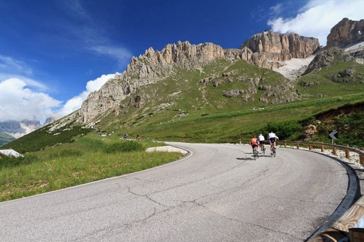 bikers on the road from Canazei to Pordoi pass, Trentino, Italy