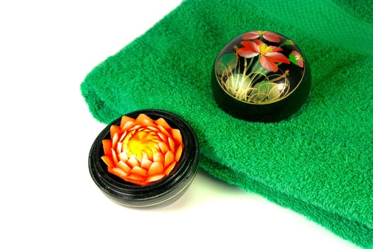 Aromatic blossom candle and green towel