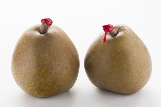 Green pears with red sealing wax on stalk