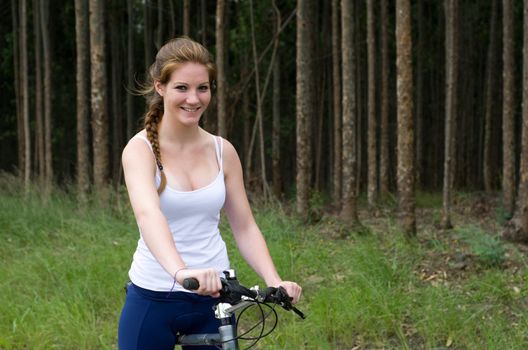 Active girl woman in forest with mountain bike