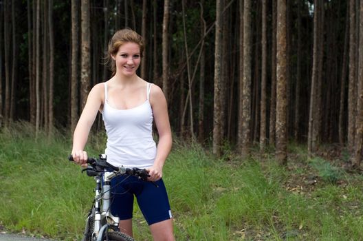 Active girl woman in forest with mountain bike