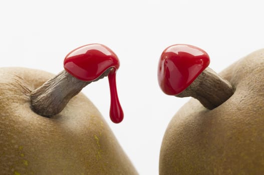Green pears with red sealing wax on stalk