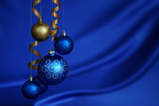 christmas balls on blue satin background
