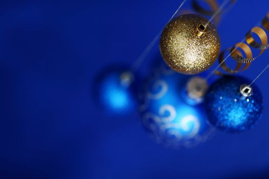 christmas balls on blue satin background
