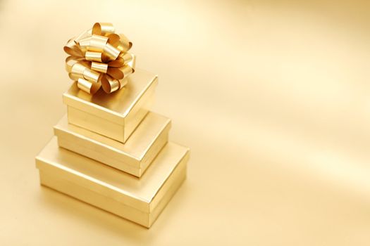 golden christmas gifts on gold background 