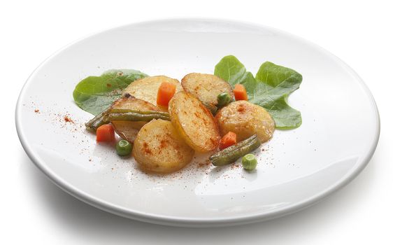 Fried potato with lettuce and vegetables on the white plate