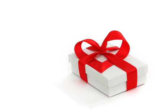  white christmas gift with red heart ribbon