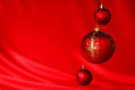  christmas balls on red satin background