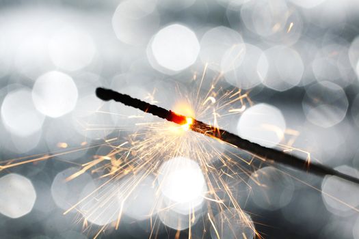 sparkler on silver bokeh background macro close up