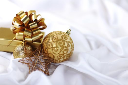  gold christmas ball on white silk