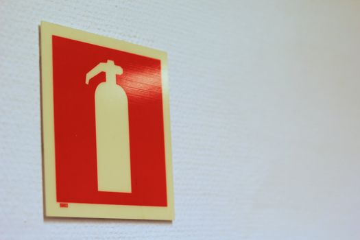 Fire extinguisher sign on office wall