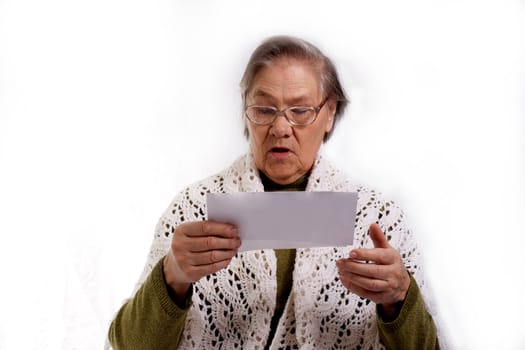 old woman shocked about her bills isolated on white background