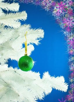 Green ball hanging on the Christmas tree