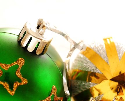 two christmas balls with golden details over white background macro