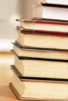 old dusty closed books stack on table