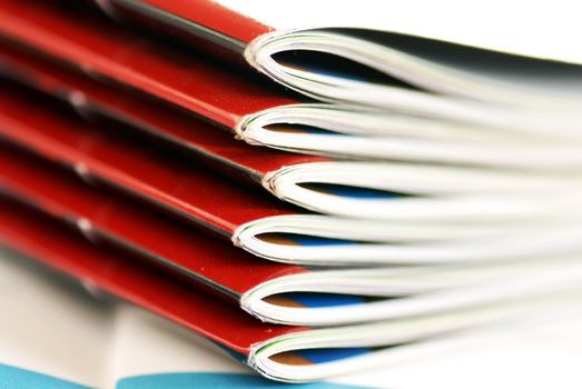 stack of same magazines with red covers closeup
