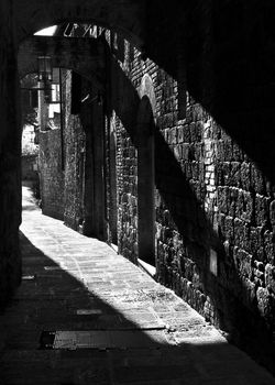 Narrow street in San Gimignano, Italy, black and white photography