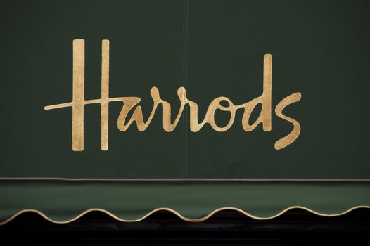 Harrods golden sign on green awning