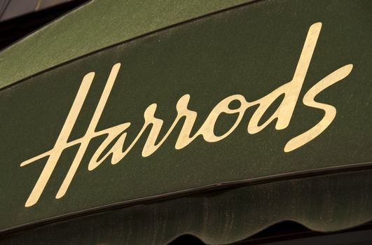 Harrods golden sign on green awning