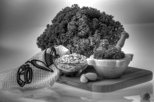 Parsley, pine nuts and garlic on wooden board