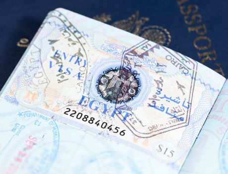 Macro image of visa and immigration stamps in US passport for Cairo Egypt