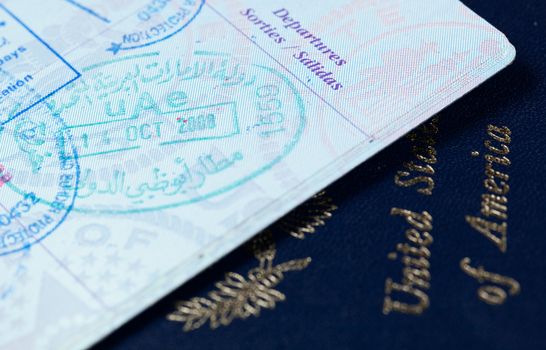 Macro image of visa and immigration stamps in US passport for Dubai or Abu Dhabi in the UAE