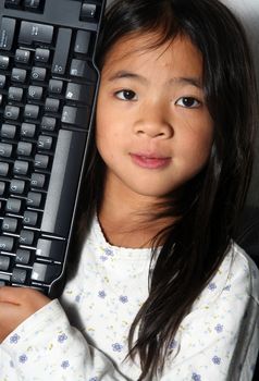 young child - girl- with computer keyboard