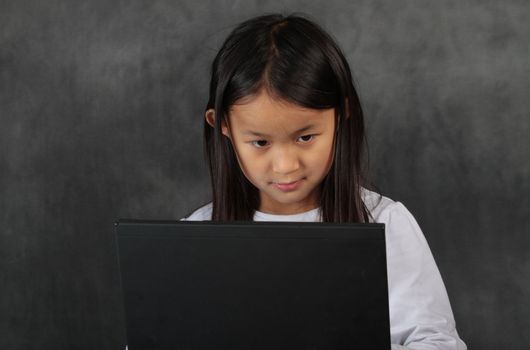 young child - girl- with computer keyboard