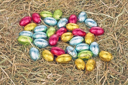 Little colored eggs in straw