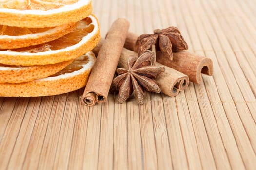 detail of Star Anise, cinnamon and dried orange  on wooden background 