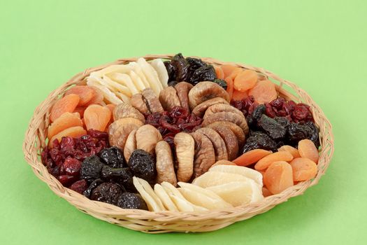 various dried exotic fruits on green background