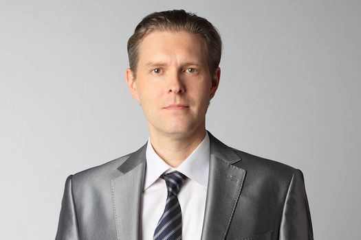 portrait of middle age businessman in austere suit