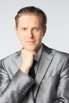 portrait of middle age businessman in austere suit