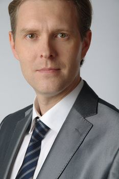portrait of middle age businessman in austere suit