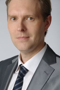 portrait of middle age businessman in austere suit